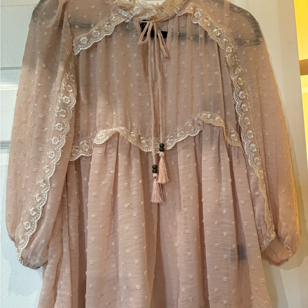 Bohemian-style pink/peach blouse.‎